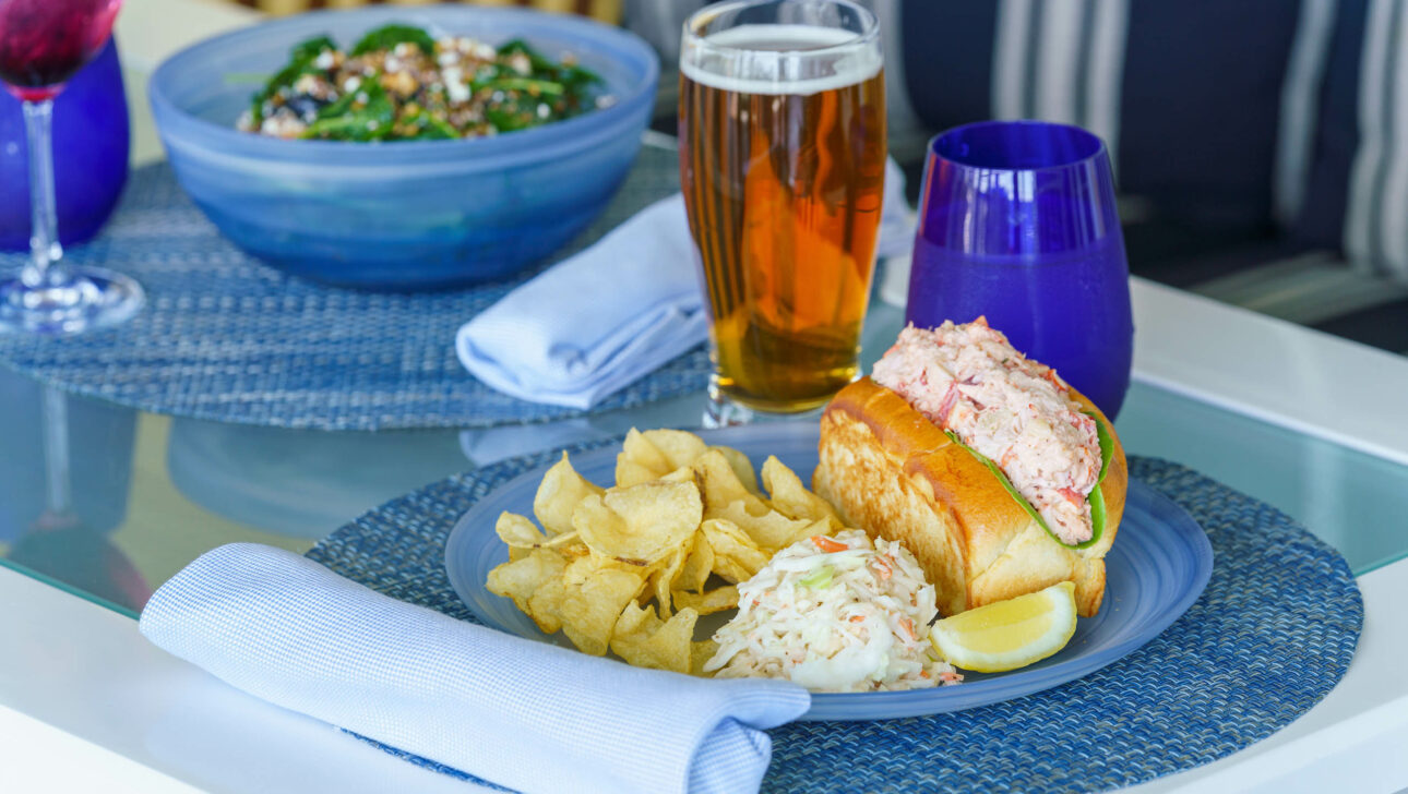 A lobster roll and a glass of beer at the Verandah Raw Bar.