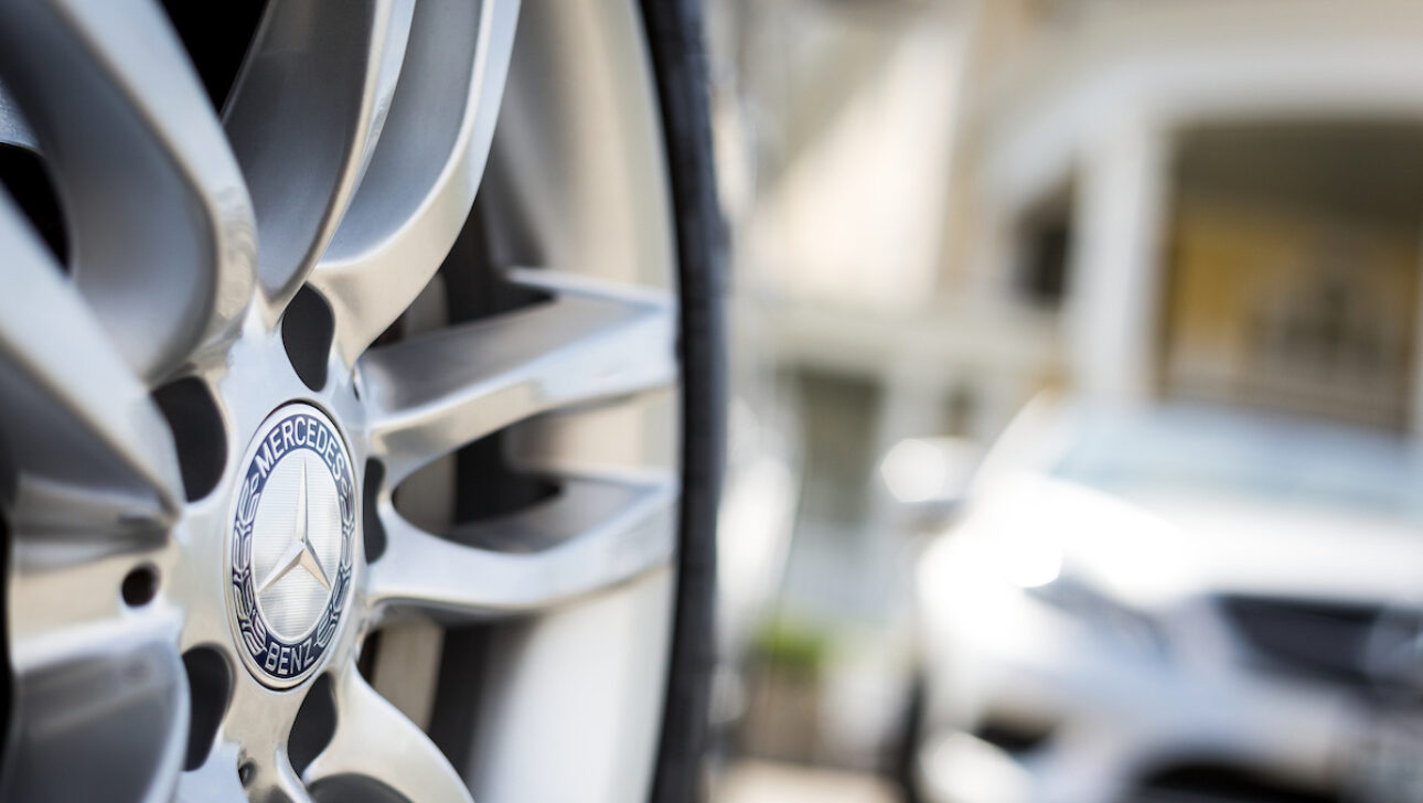 A close up of a Mercedes Benz wheel.